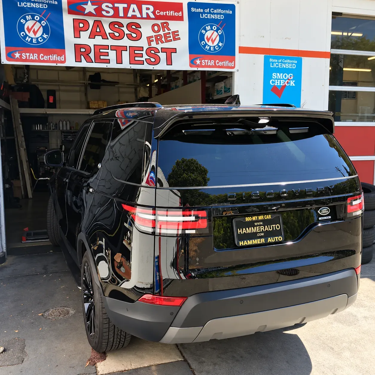 Black Land Rover at the Star Smog San Mateo service bay