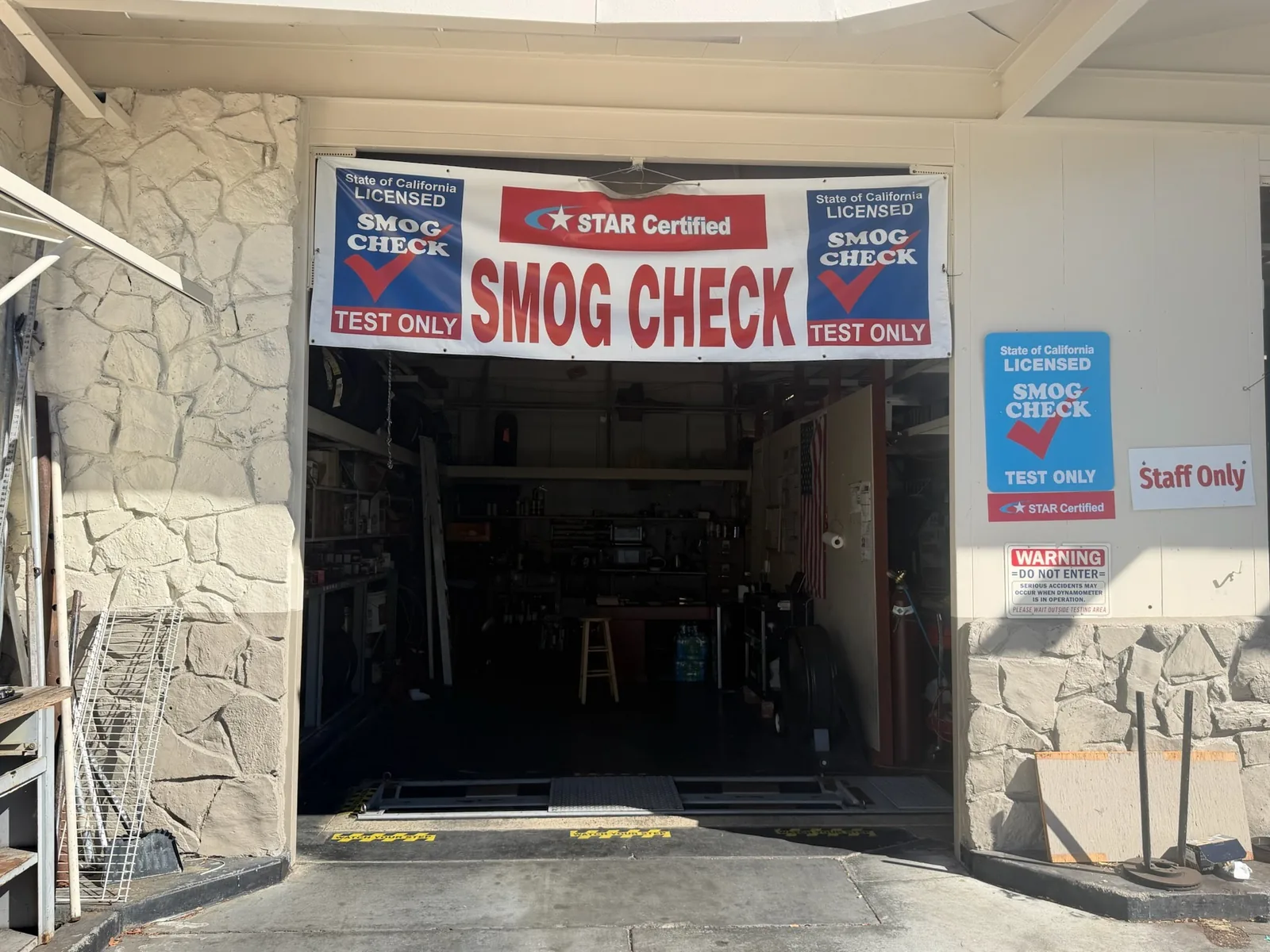 Close view of the smog inspection bay entrance and STAR Certified signs at Star Smog San Mateo